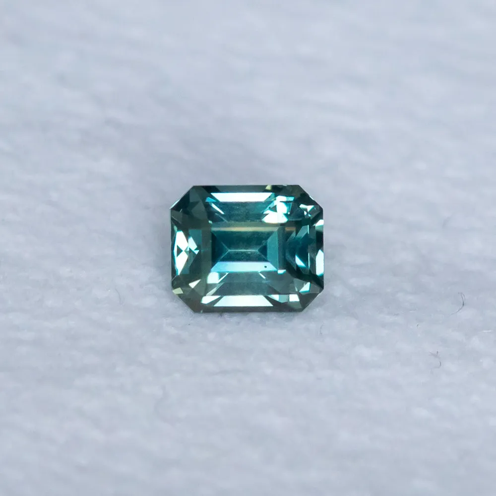 1.26CT EMERALD CUT MADAGASCAR SAPPHIRE, TEAL TO GREY, 5.7X4.79X4.44MM