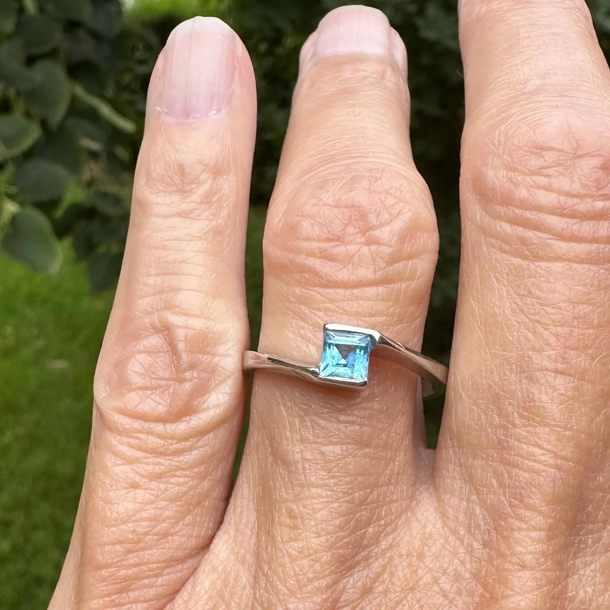 Bypass 10K White Gold Emerald Cut Blue Topaz Ring