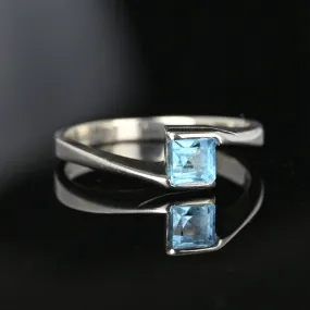 Bypass 10K White Gold Emerald Cut Blue Topaz Ring