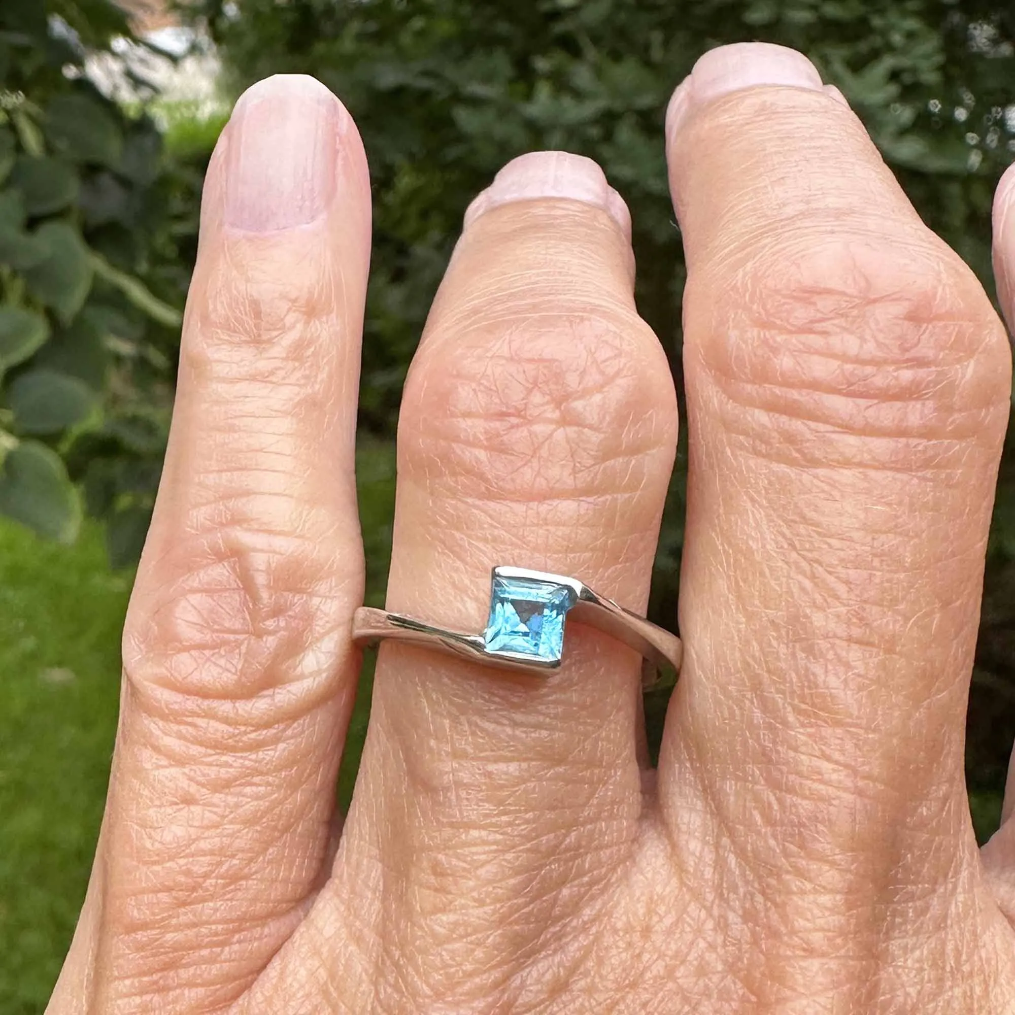 Bypass 10K White Gold Emerald Cut Blue Topaz Ring